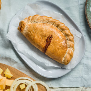 Prima Bakeries handmade traditional steak pasty surrounded with fresh ingredients such as beef skirt and onion
